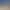 Vue aérienne d'une petite plage de sable avec deux transats sous un parasol et une table dressée sur une terrasse en bord de mer