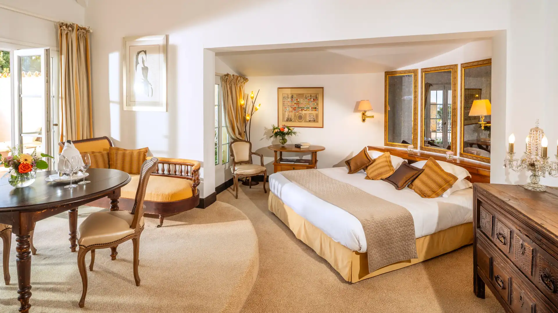 Chambre élégante avec lit double, table à manger, chaises, commode et décorations florales